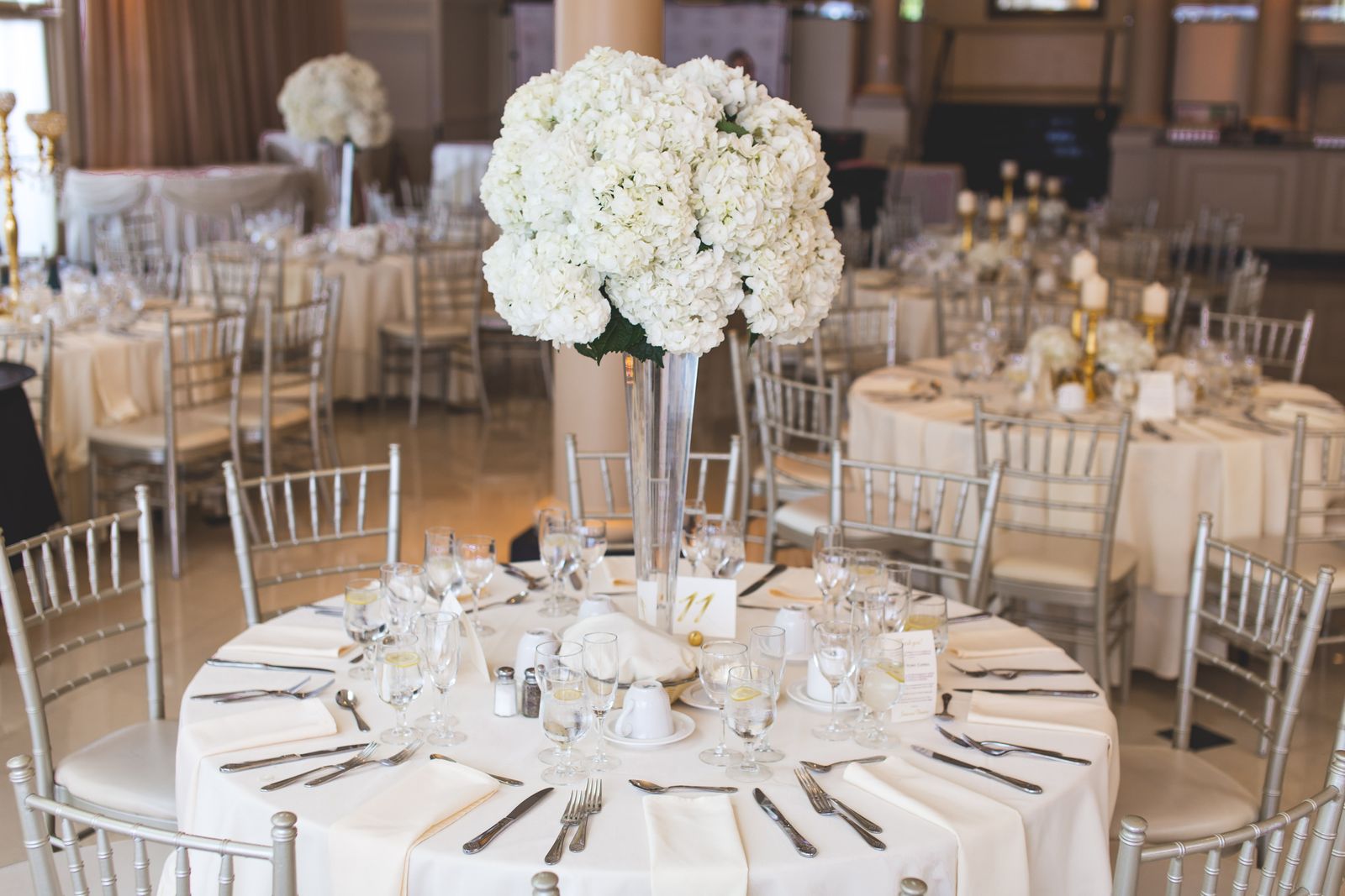 Elegant wedding reception table with floral centrepiece and place card