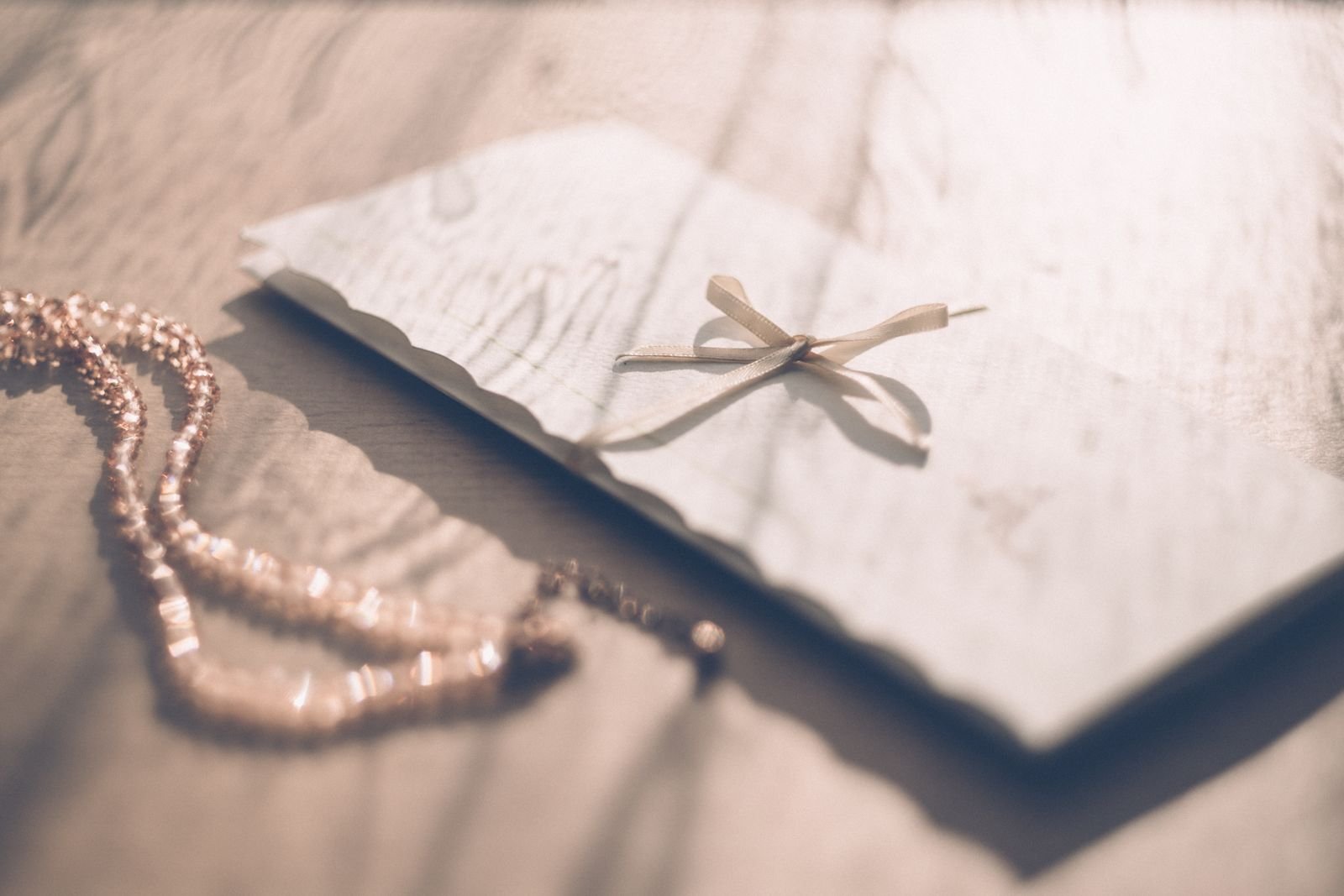 Elegant envelope tied with a ribbon on a wooden table